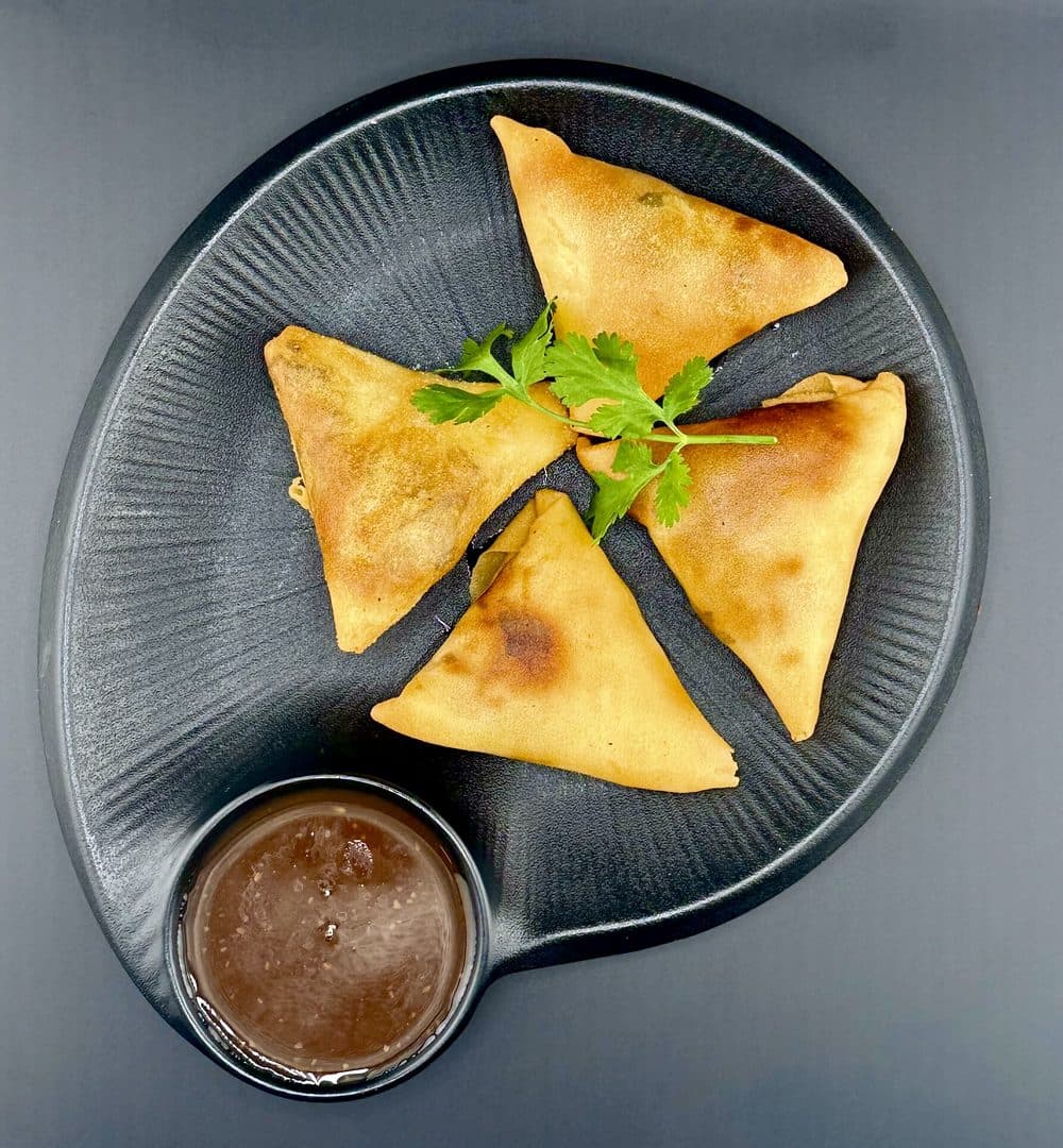 Cocktail samosas with a side of chutney